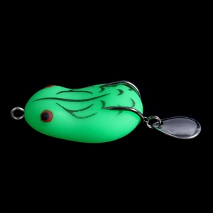 Detail view of green soft plastic frog lure with double hooks and metal spinner blades