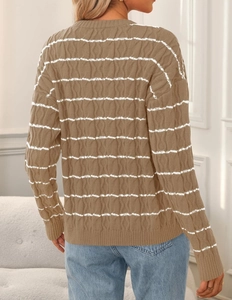 Close-up of cable knit texture and brown white striped patterns on a women cardigan