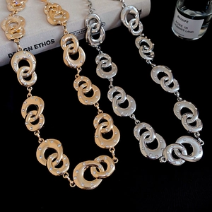 Detailed macro view of interlocking circular metal waist chains with sparkling rhinestones