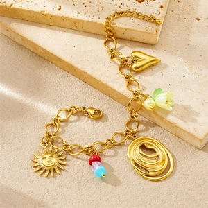 Gold chain bracelet featuring sun, colorful beads, and lily of the valley floral charms