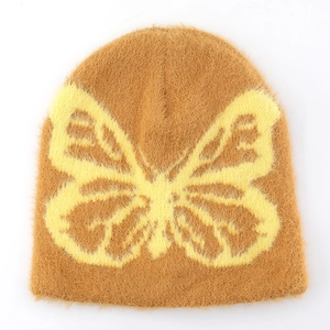 Detail of soft brown faux mink beanie featuring a large yellow butterfly jacquard pattern