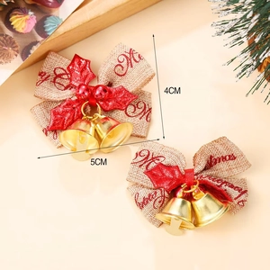 Mini burlap Christmas bow with red holly leaves and golden bells for cake decoration