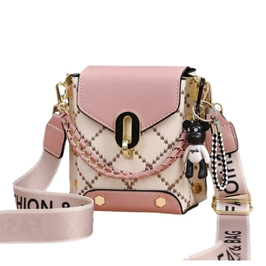 Pink and beige minimalist crossbody bag with diamond stitching and bear charm accessory