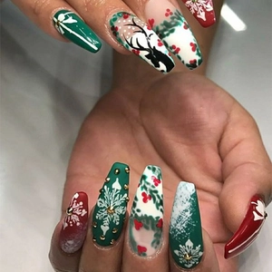 Christmas matte press-on nails featuring reindeer, snowflakes and holly in coffin shape