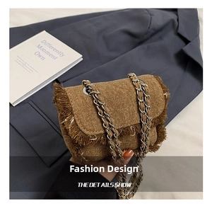 Detail view of brown frayed denim crossbody bag for kids with silver chain strap