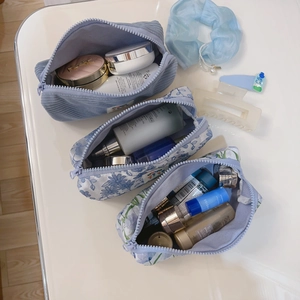Set of three blue floral and corduroy storage bags for cosmetics and stationery