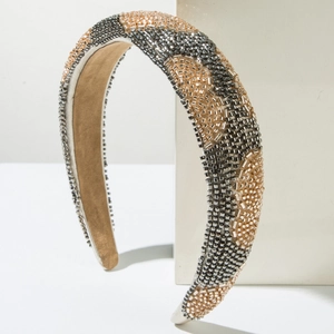 Detailed view of handmade beaded headband with metallic waves and soft suede lining
