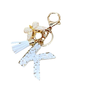 Letter K keychain with white resin, gold butterfly charm and tassel for bag accessory