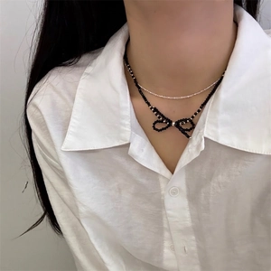 Double layered necklace with black beaded bow pendant and silver chain for women