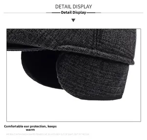 Detail view of winter flat cap showing foldable fleece ear flaps and tweed texture