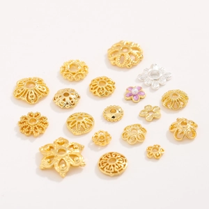 Detailed macro of 18K gold-plated hollow flower caps and purple enamel jewelry spacers