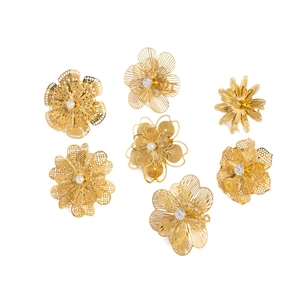 18K gold plated hollow camellia flower rings set with pearls and crystals on white background