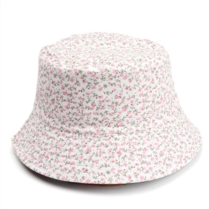 Detailed close-up of stitching and pink floral pattern on a double-sided sun hat