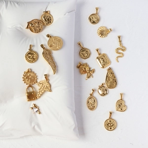 Detailed close-up of 18K gold plated titanium steel charms including snake, coin, and rose