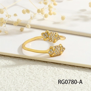 Detail of 18K gold plated open ring with micro-set cubic zirconia on white surface
