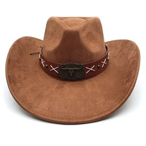 Detail of western cowboy hat featuring a leather band and metallic bull head buckle