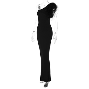 Detail of elegant black one-shoulder evening dress featuring luxury feather trim on shoulder