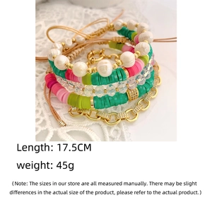 Detail shot of bohemian multilayer beaded bracelet featuring colorful clay discs and pearls