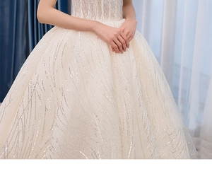 Detail of luxury bridal gown with intricate sequin embroidery and sparkling textures
