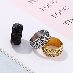 Vintage men's wide stainless steel ring with geometric textures in black, silver and gold