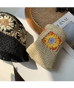 Close-up of handmade crochet flower bucket hats with vintage woven textures and patterns