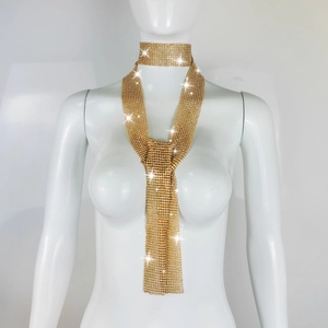 Detail of shimmering gold metallic mesh scarf necklace set displayed on a white mannequin