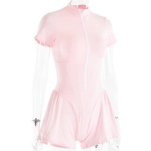 Detail of pink short-sleeve romper with front zipper and pleated skirt design