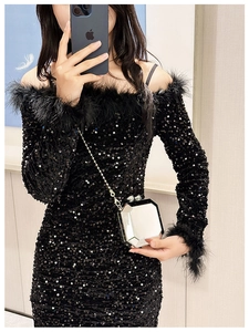 Detail of silver geometric mirror clutch bag with chain and black sequin feather dress
