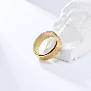 Detail of golden spinner ring showing the Eye of Horus relief on a stone surface