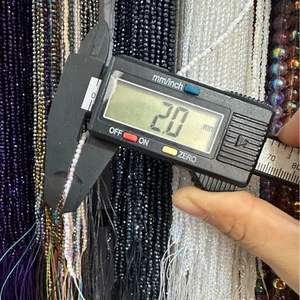 Macro shot of 2mm faceted glass beads measured with digital caliper for DIY jewelry