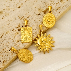 Golden celestial tarot pendants featuring sun and moon designs on elegant silk background