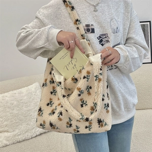 Detail of floral plush tote bag interior capacity showing large storage space for books