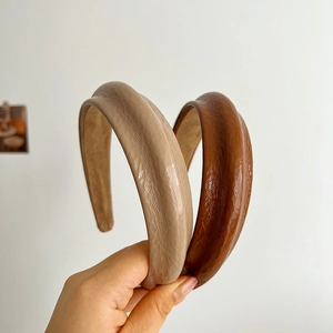 Padded leather headbands in beige and brown with elegant pleated texture for women