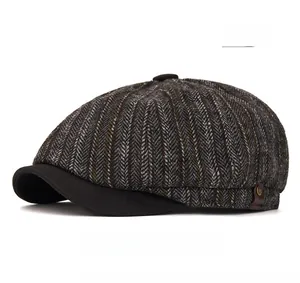 Macro detail of gray newsboy cap with herringbone texture and leather side label decoration