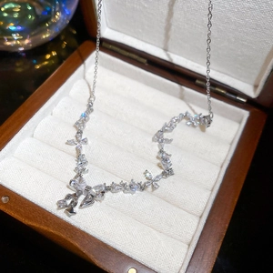 Macro shot of silver zircon butterfly pendant on a soft velvet lining jewelry box