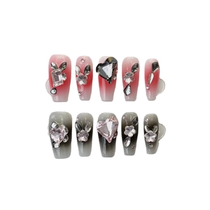 Handmade press-on nails featuring pink and grey gradients with luxury 3D rhinestone heart accents