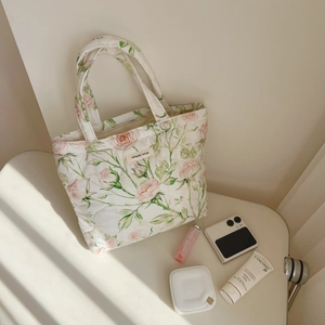 Quilted floral tote bag with pink roses and 'simple wish' label on a white surface