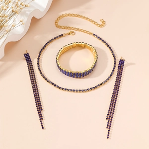 Golden jewelry set featuring a necklace, bracelet, and blue crystal tassel earrings