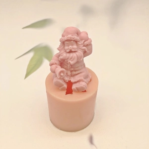 Pink silicone mold featuring a 3D sitting Santa Claus for DIY candles and crafts