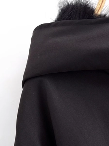 Detail of black hooded jacket with high-quality faux fur trim and textured fabric