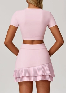 Rear view of pleated pink athletic skirt with tiered hem and breathable sports fabric