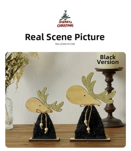 Close-up of decorative wooden reindeer set with gold glitter antlers and plush body