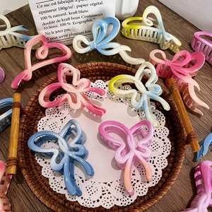 French style gradient bow shark clips in various pastel colors on a lace-covered tray