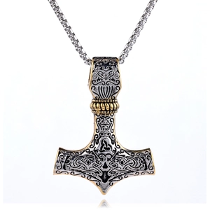 Macro detail of Mjölnir pendant with intricate Celtic patterns and two-tone metal finish
