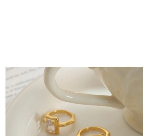 Close-up of gold plated rings with rectangle zircon and unique irregular wavy textures