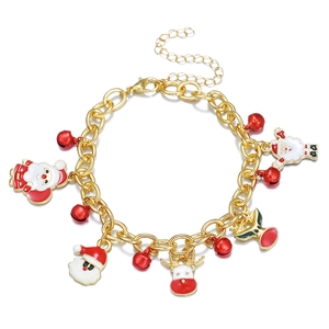 Detailed close-up of Christmas charm bracelet with gold chain, Santa and reindeer charms