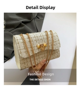 Detail of cream tweed shoulder bag with gold chain strap and triangle metal buckle