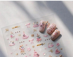 Detail of pink Christmas nail stickers with 3D gold embossed bears and reindeer patterns