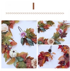 Detailed close-up of autumn maple leaf wreath with mini pumpkins and pine cones