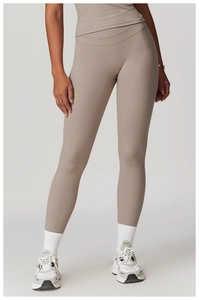 Detail of high-waisted seamless yoga pants in terracotta with matte texture fabric